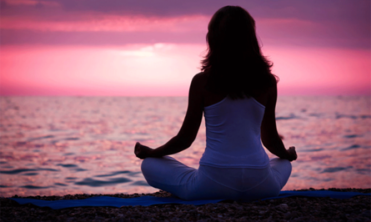 lady meditating by the beach