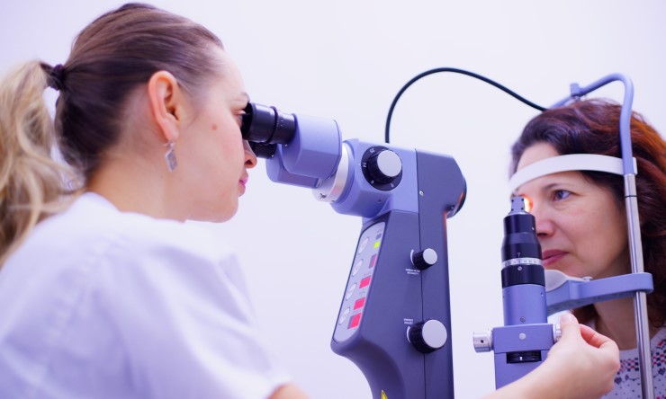 Optometrist giving a woman an eye test