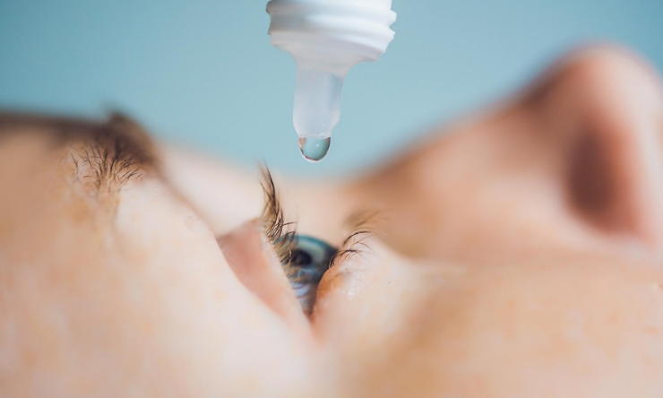 Image of an eye drop being administered to an eye