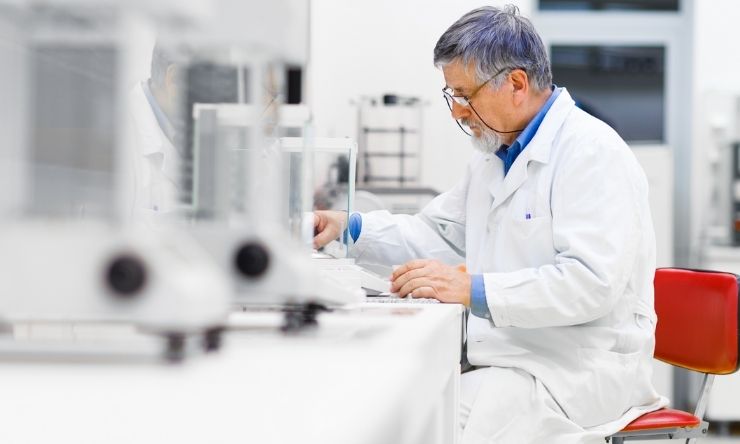 Male lab technician conducting test and recording data