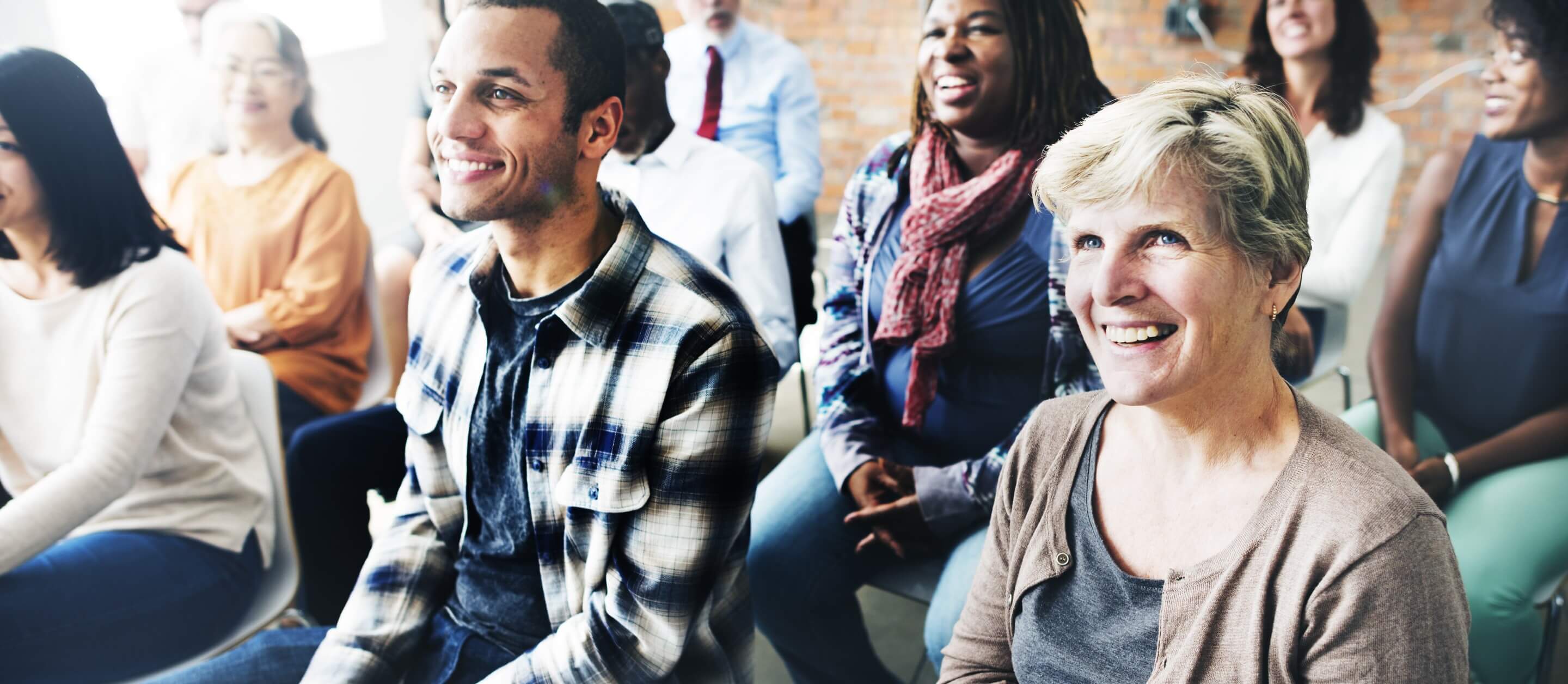 A diverse group of people sitting in an audience