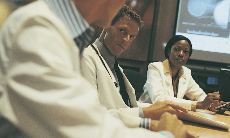 Scientists conducting meeting in board room