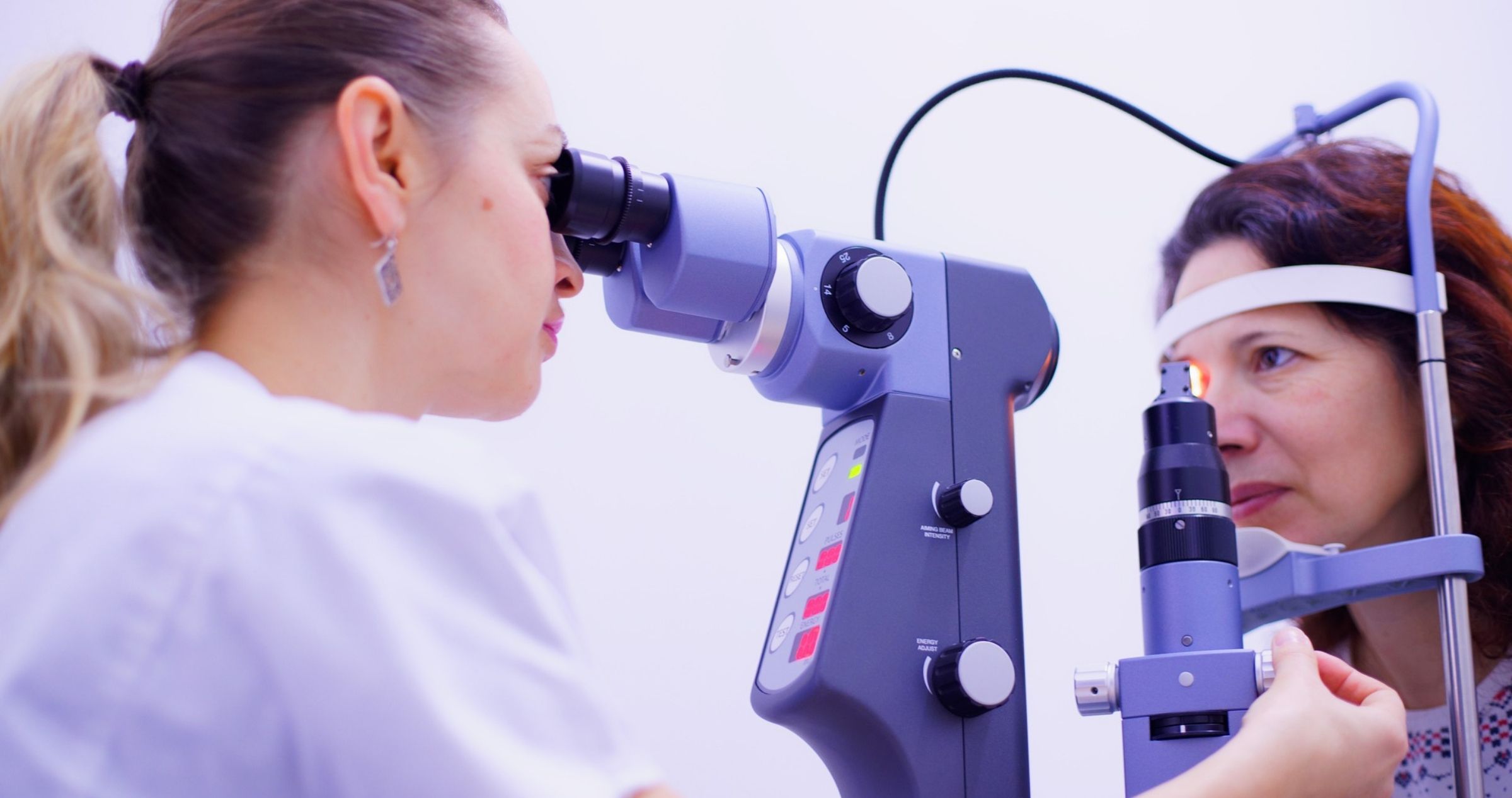 Eye health care professional giving woman an eye test