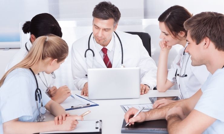 Group of health care students sitting at desk having meeting