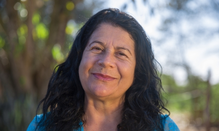 Close up image of woman with dark hair in garden