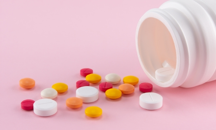 Image of assorted tablets with pale pink background