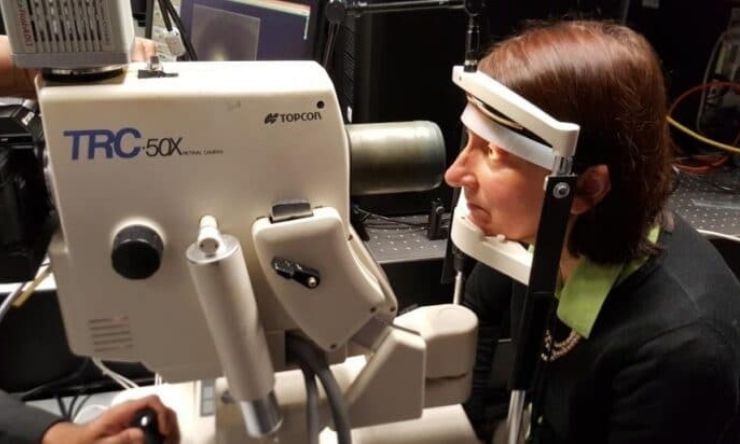 Imaging of woman having eye scan in laboratory