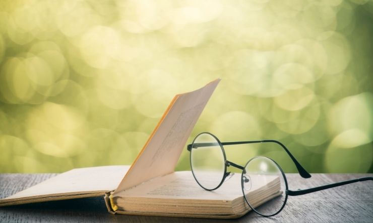 Image of reading glasses resting on a book 