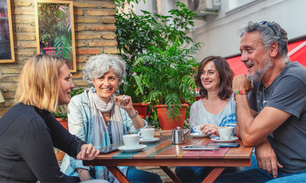 A group of people having coffee at a cafe outdoors