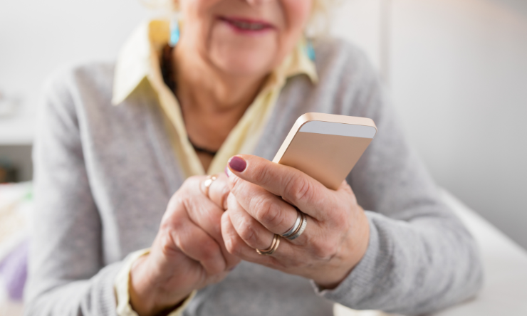 An older woman using a mobile phone