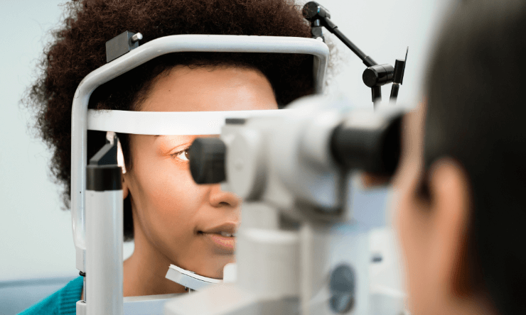 An African woman having her eyes examined by an optometrist
