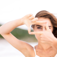 Woman using her fingers to create a box for her eyes