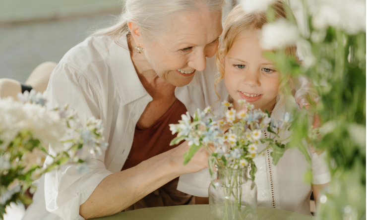 Grandmother looking a flowers with grandchild