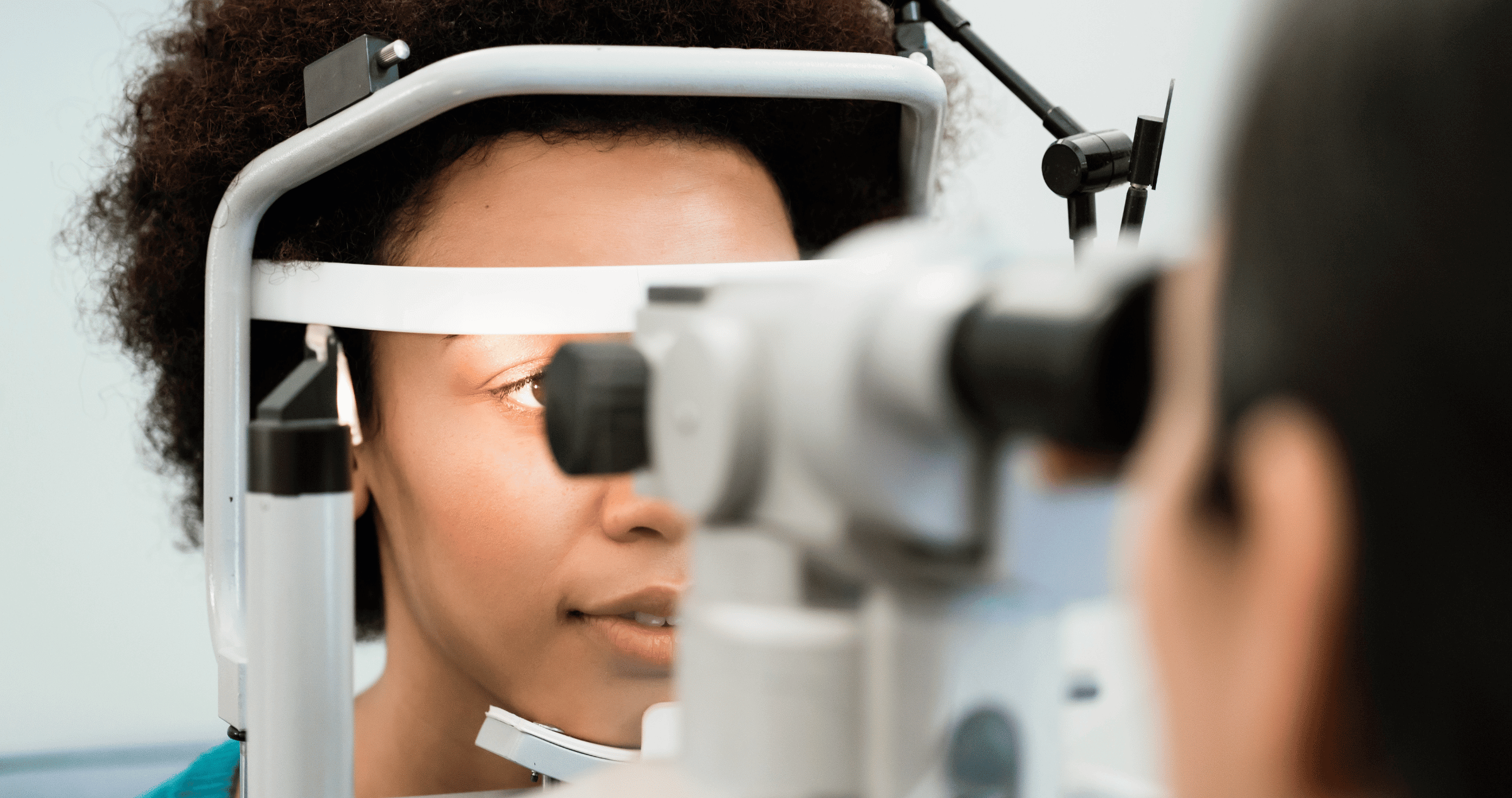 An African woman having her eyes examined by an optometrist