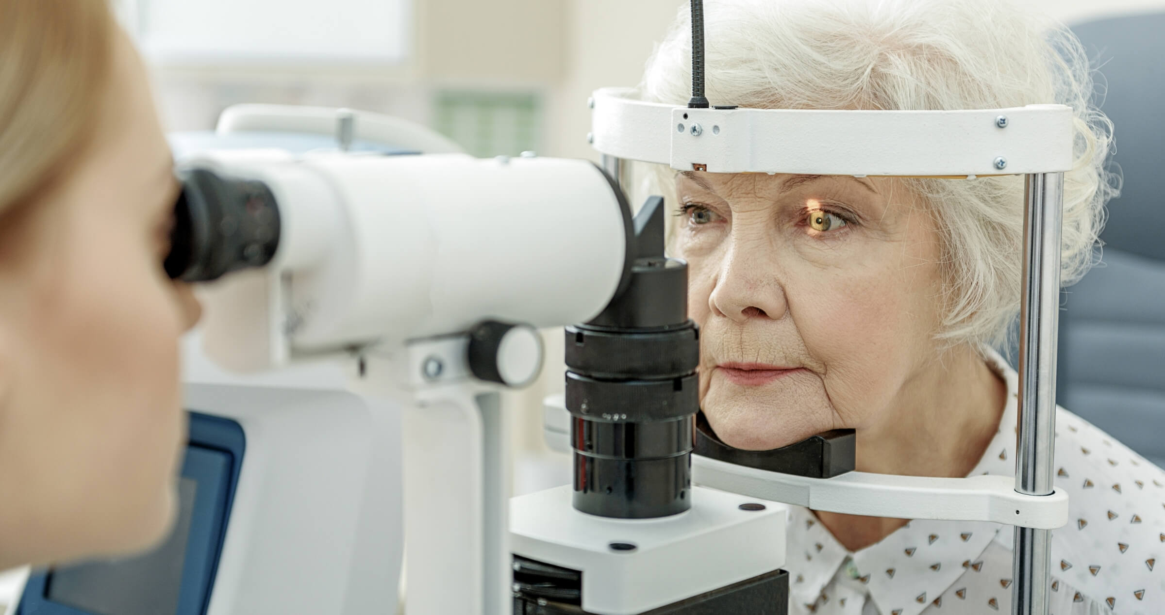 Image of older woman receiving an eye exam