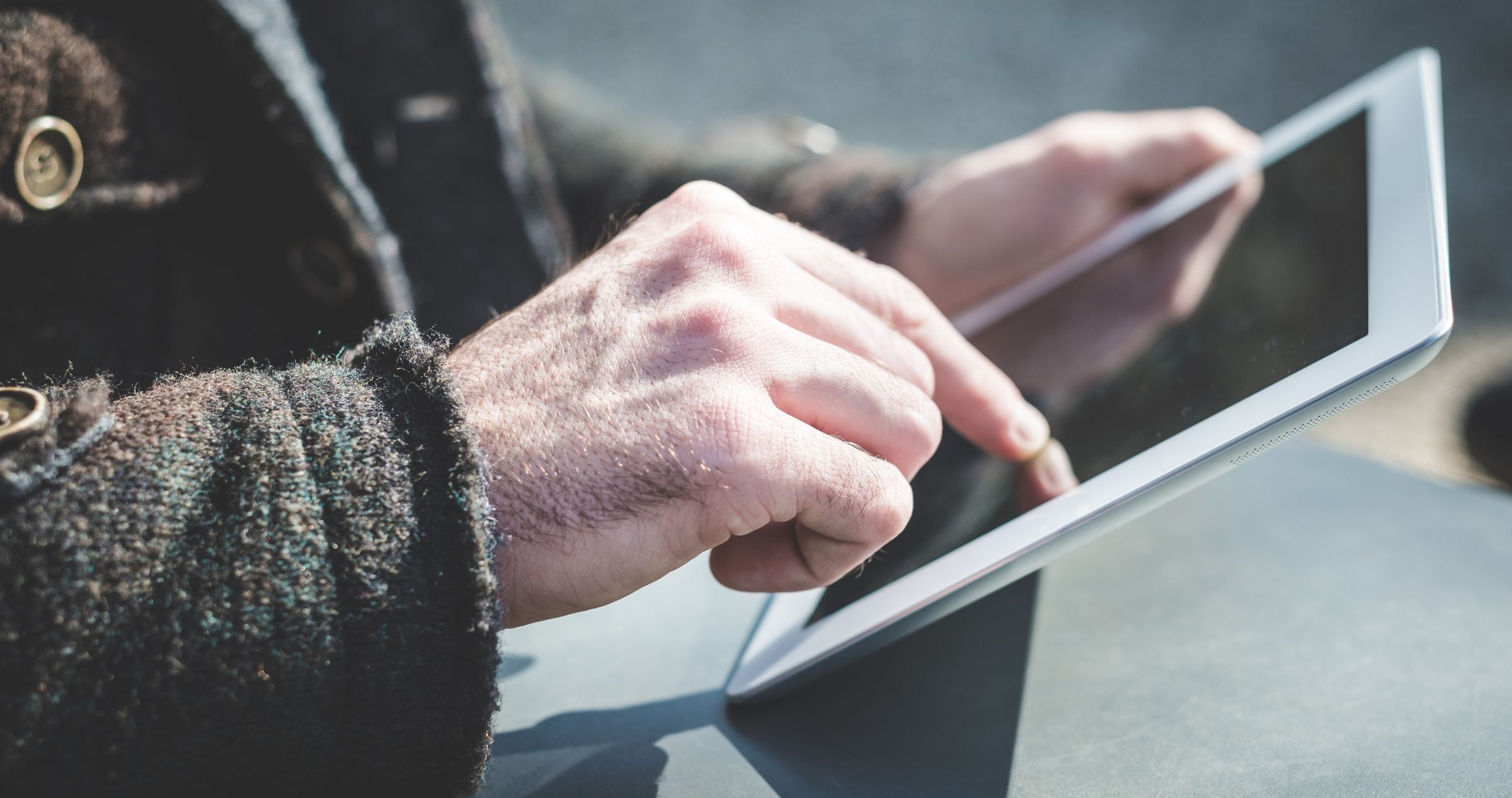 Image of elderly hands holding smart device