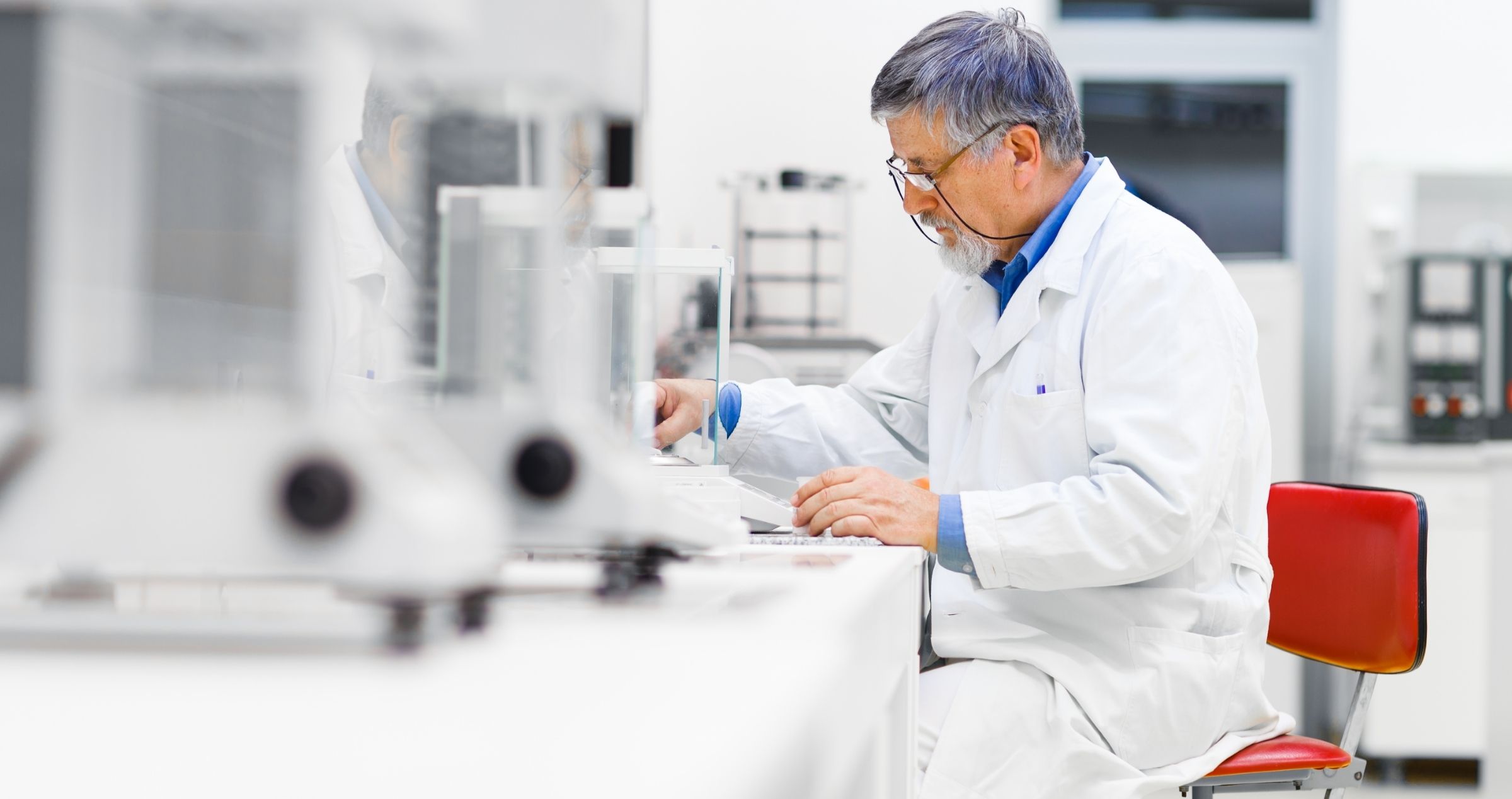 Male lab technician conducting test and recording data