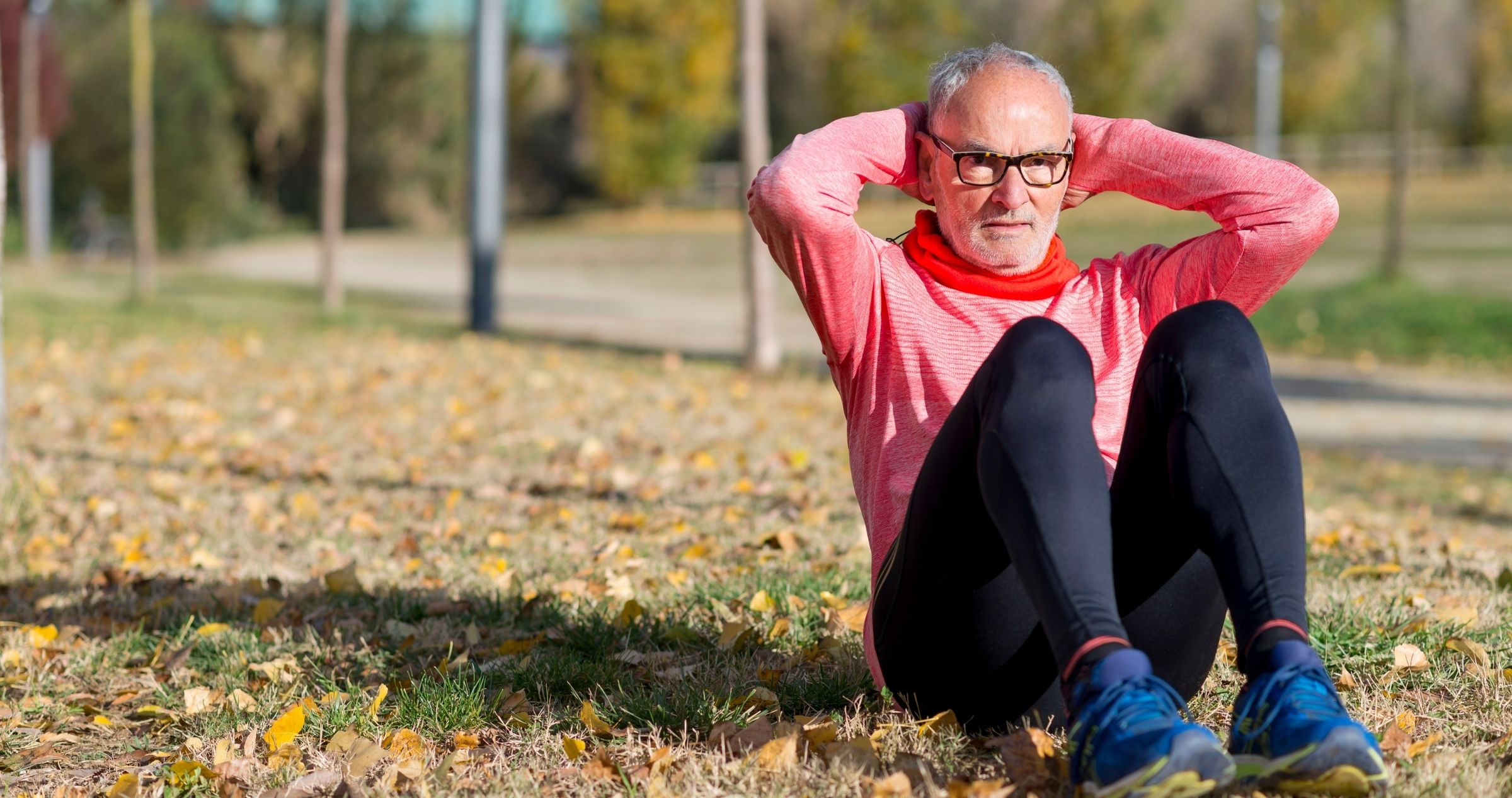 image of older man in park doing sit ups