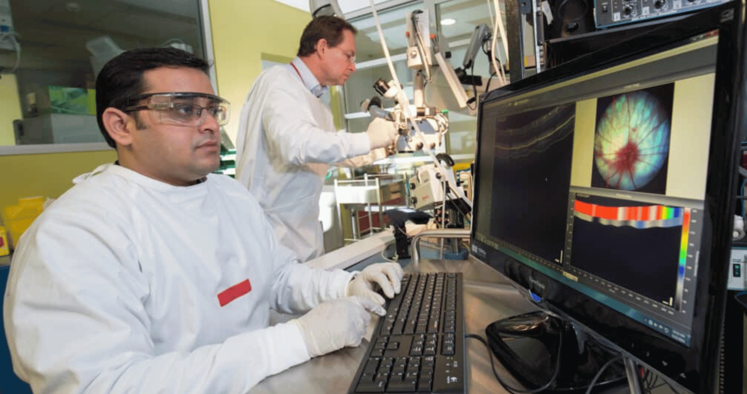 Macquarie ophthalmology researchers Dr Nitin Chitranshi (seated) and Professor Stuart Graham working in a lab