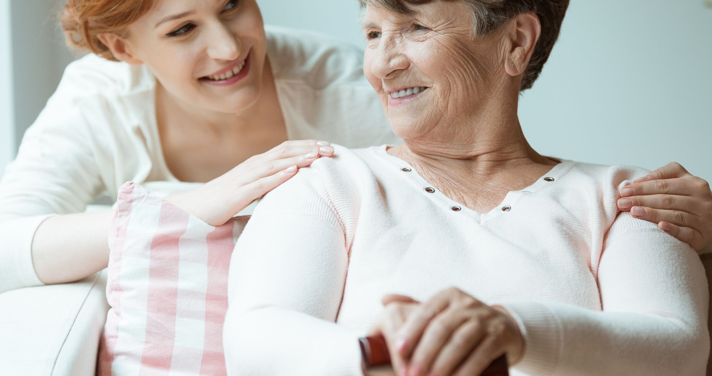 Older woman being comforted by younger woman