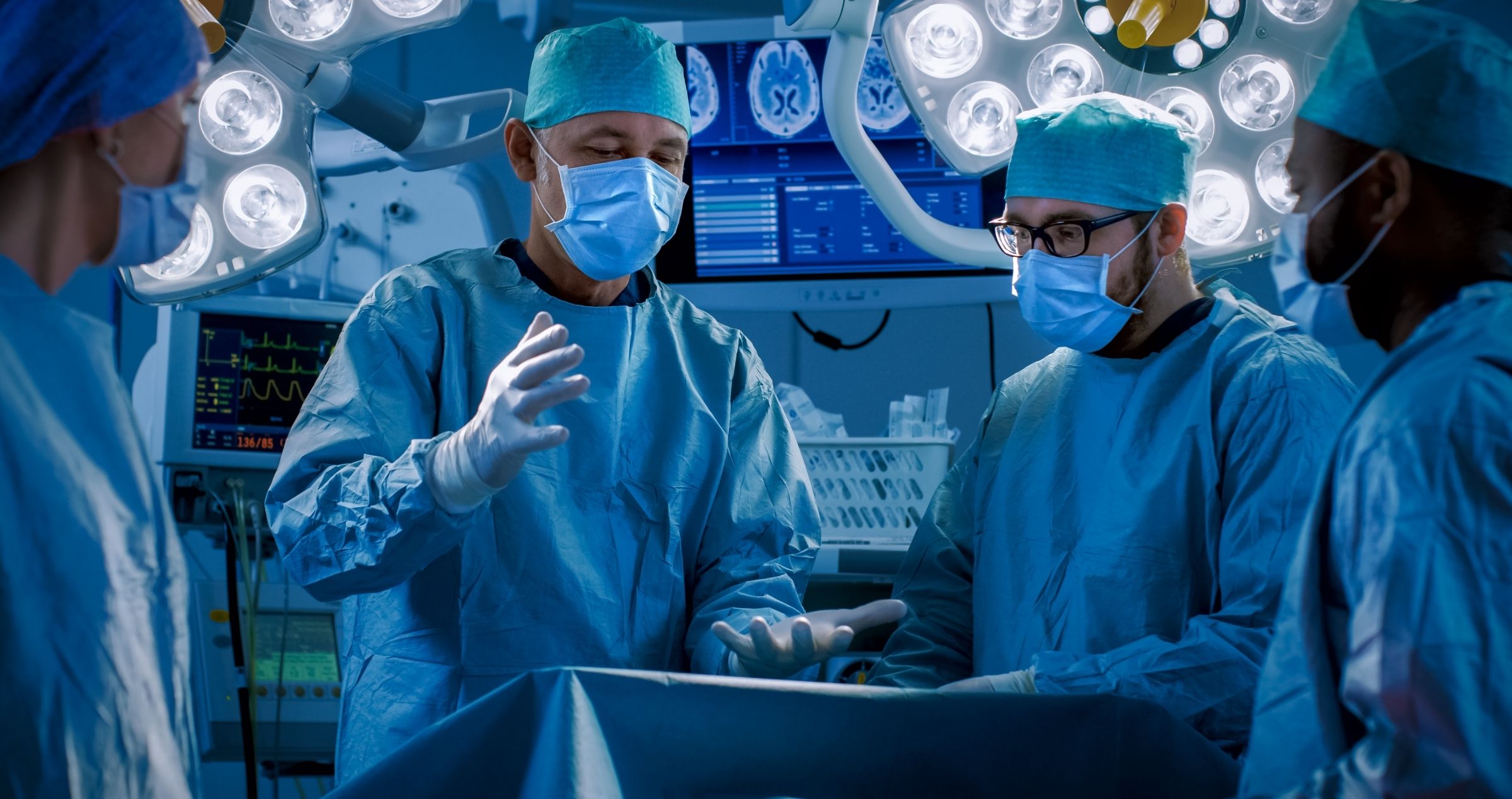 Surgeons in operating theatre with patient