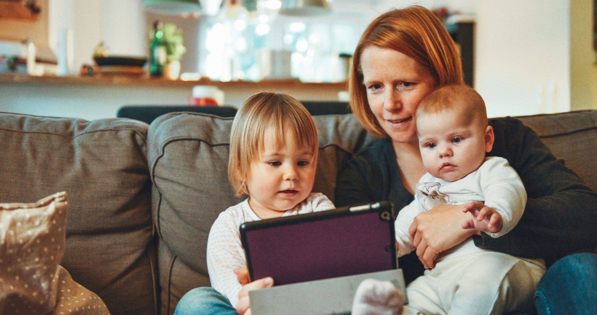 Mother reading to children on tablet