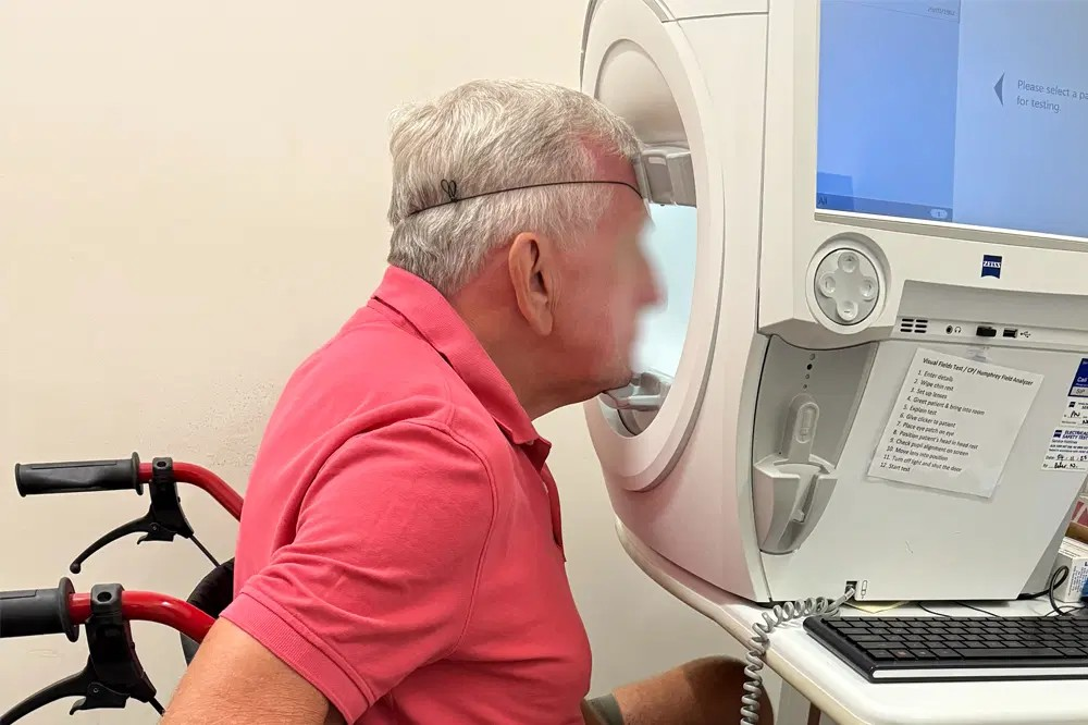 Man taking a visual field test in a wheelchair