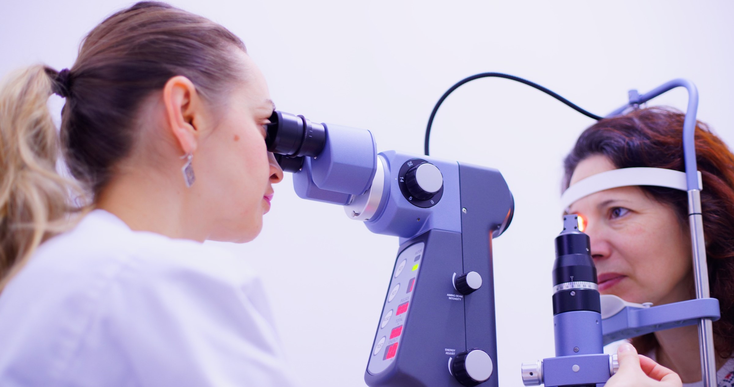 Optometrist giving a woman an eye test