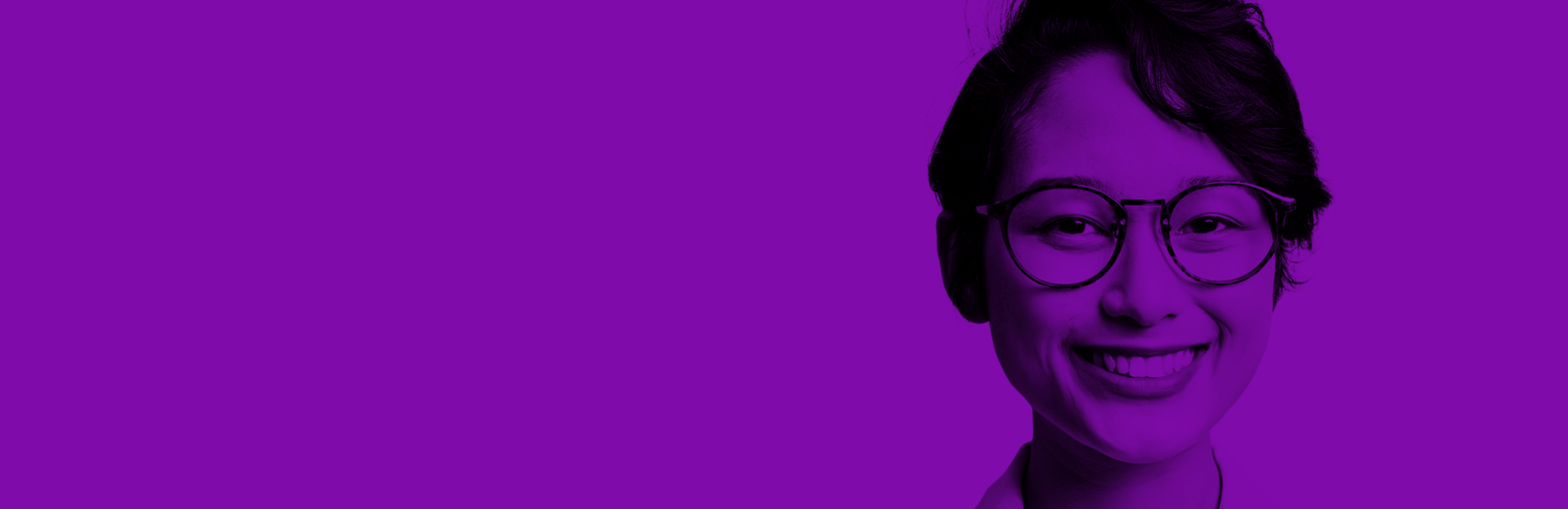 Young woman wearing glasses smiling at the camera