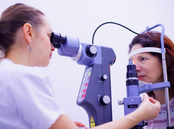 Female ophthalmologist treating a woman's eye using glaucoma laser treatment